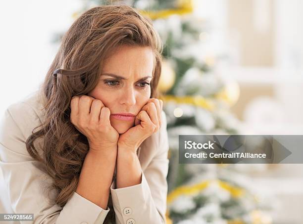 Portrait Of Frustrated Young Woman Near Christmas Tree Stock Photo - Download Image Now