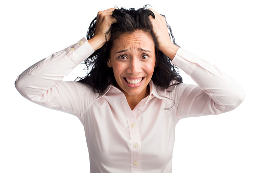 Businesswoman pulling her hair in frustration isolated over white background