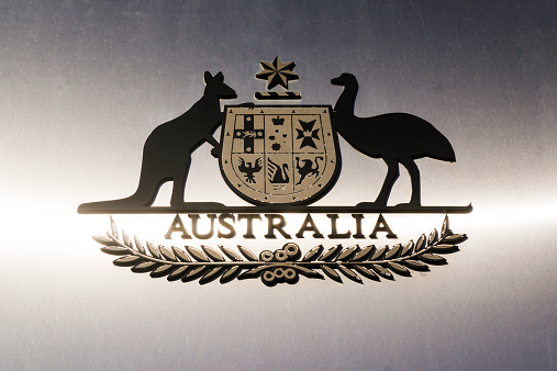 The Coat of Arms of Australia, seen on a reflective metal surface outside the High Court in Canberra.