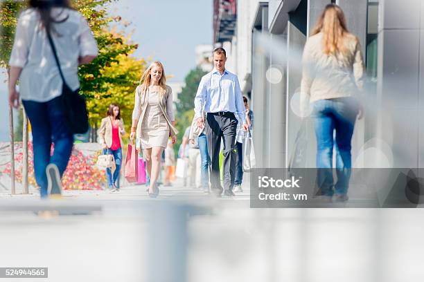 Couple On Crowded City Street After Shopping Stock Photo - Download Image Now - Pedestrian Zone, Shopping, Street