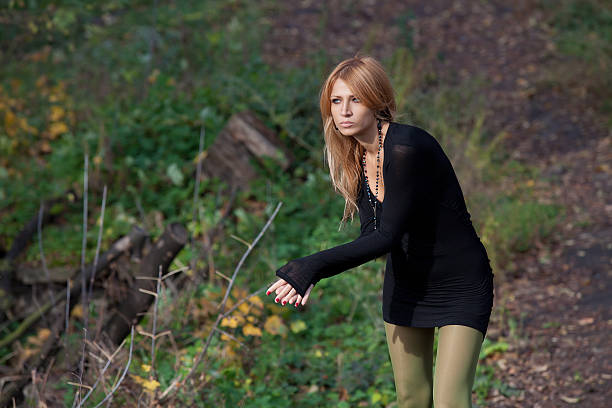 istock Interesting mysterious blonde walks in autumn forest 524948981