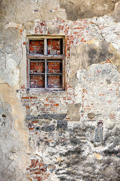 istock Closed blocked window and old stone wall background 524949119