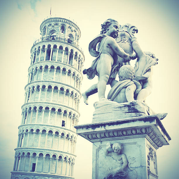The Leaning Tower of Pisa and La Fontana dei Putti Statue, Italy. Retro style toned image