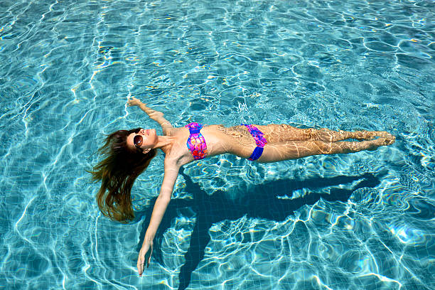 istock Girl relaxing in a pool 525002121