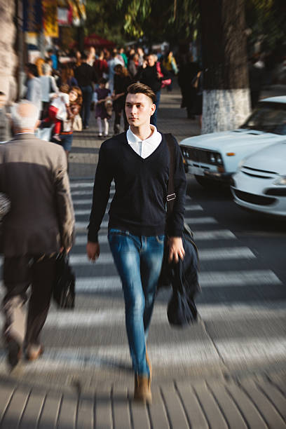 istock Young man cross the street 525003131