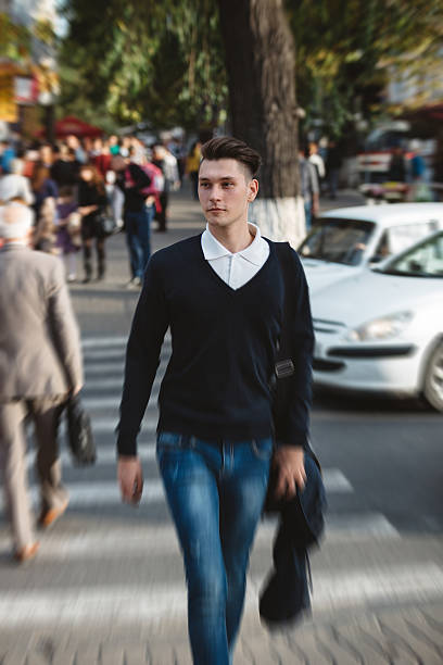 istock Young man cross the street 525003137