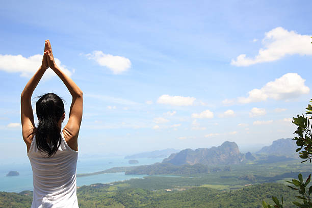 istock young woman practice yoga at mountain peak 525011782