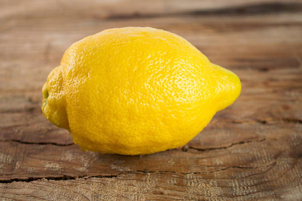 istock Fresh lemon on wooden background 525014526