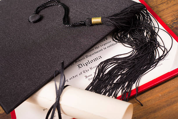 istock Graduation!  Cap, motarboard and tassel with dilplomas on table. Education. 525015132
