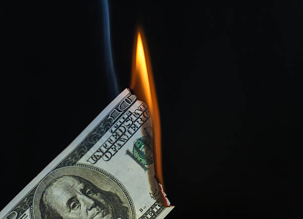 istock Hundred Dollar USA Bill Catching on Fire 525015428