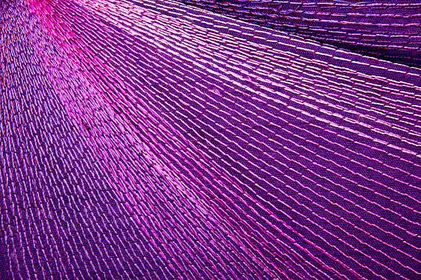 istock Intricate Colorful Stitching Forming Pattern on Mauve Fabric 525015999