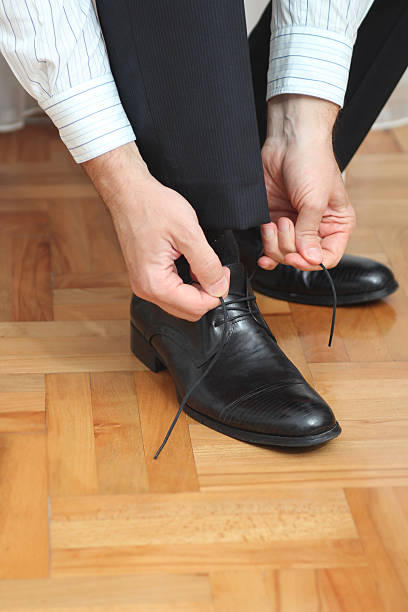 istock Groom fastening shoes 525016367