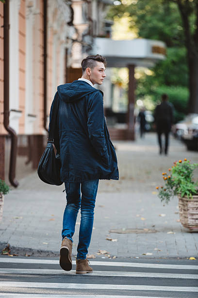 istock Young man cross the street 525016477