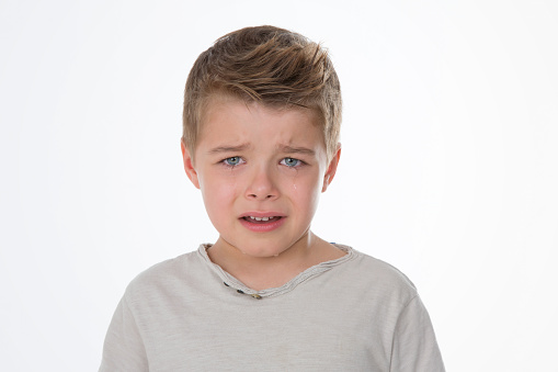 young kid with sad eyes and expression