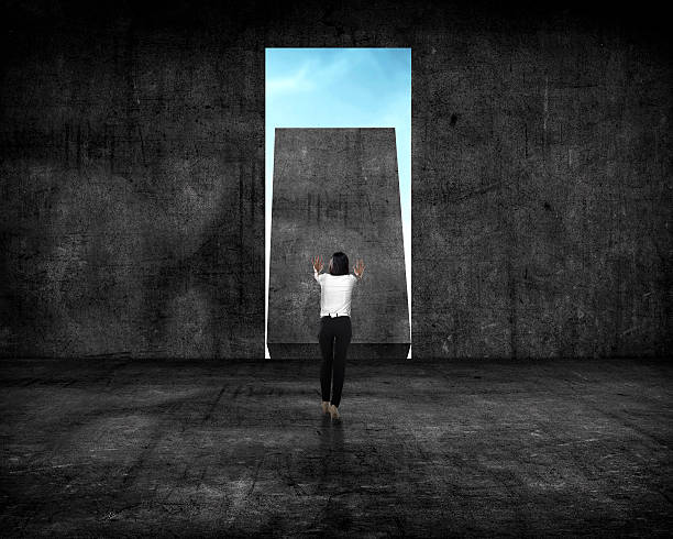 istock Asian business woman push wall 525017656