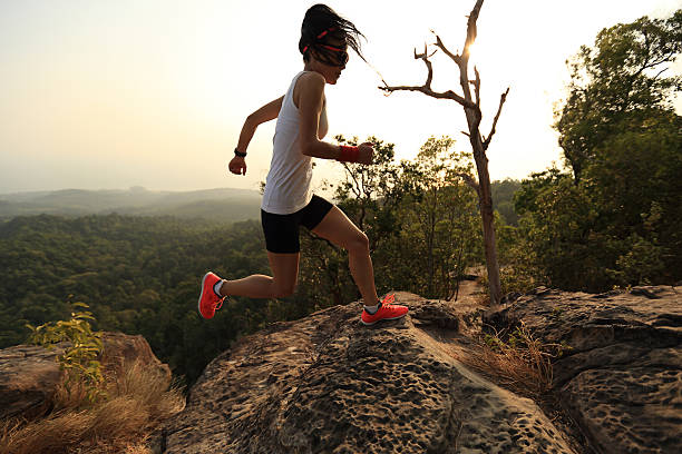istock young asian woman runner running on mountain peak 525017920