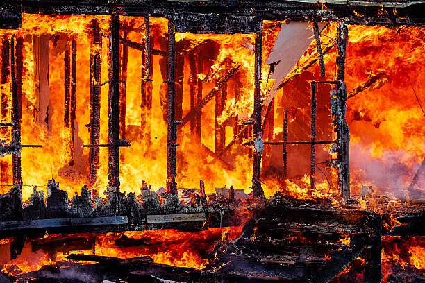 Abandoned Building Fire Department Burn Wooden building structure is fully engulfed in flames during fire department practice burn training. burning house stock pictures, royalty-free photos & images