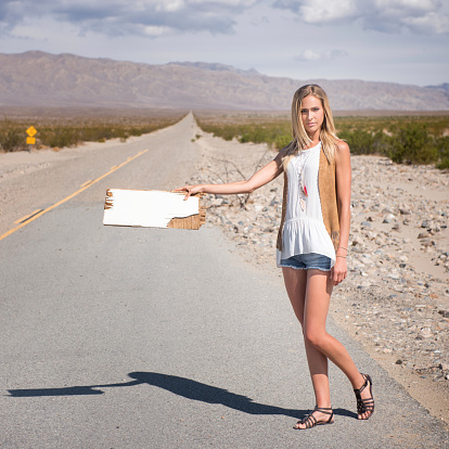 Woman Hitchhiking in the Desert, Sign with Copy Space