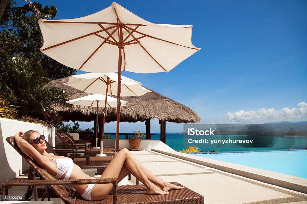 Young beautiful woman sunbathing. Nice sea view. Adult Stock Photo