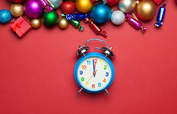 istock Alarm clock and christmas toys on red table. 525023687
