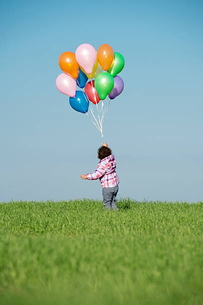 istock Child playing with colourful balloons. 525024134