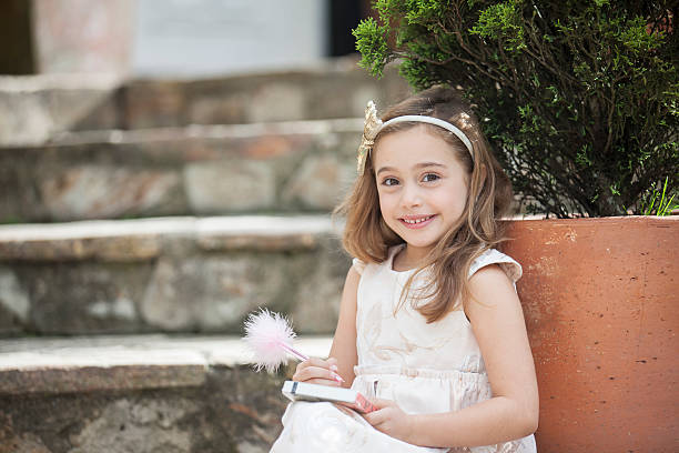 istock Little writer with her notebook and pencil 525026464
