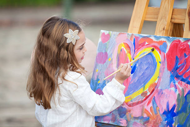 istock Little artist creating a painting 525026662
