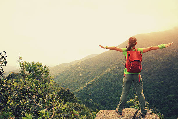 istock cheering woman hiker enjoy the view on mountain peak 525027788