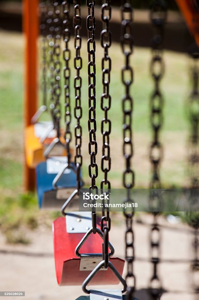 Empty colorful swings at the park Empty colorful swings at the parkEmpty colorful swings at the park Playground Stock Photo