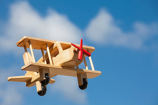 istock Wooden Plane flying with blue sky - Going up 525028412