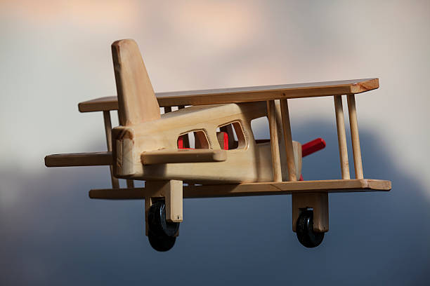istock Wooden plane flying under the stormy sky - Going up 525028484