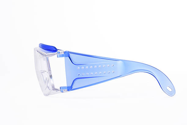 Side view of blue frame protective eyewear on white background Side view of blue frame protective eyewear isolated on white background with clipping path. protective eyewear stock pictures, royalty-free photos & images