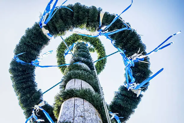 typical bavarian maypole in front of blue sky