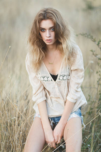 istock Young sexy model posing in a field at sunset 525030710