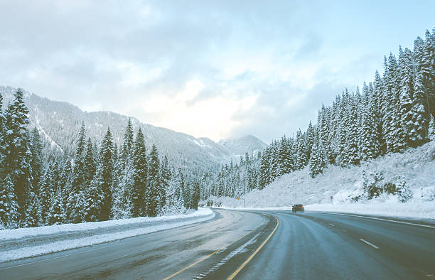 istock road with snow and mountain background in winter 525032760