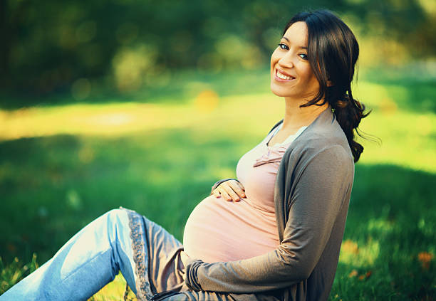 istock Smiling pregnant woman in a park. 525033368