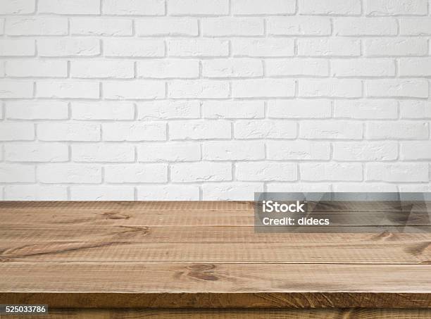 Rough Wooden Texture Table Over Defocused White Brick Wall Background Stock Photo - Download Image Now