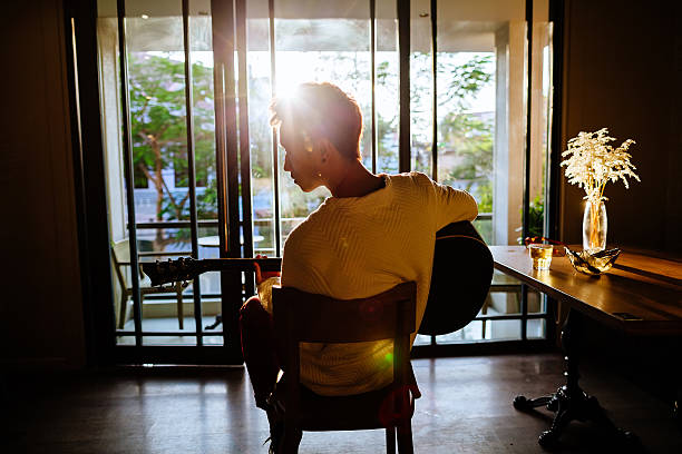 istock asian artist man play guitar in cafe sunlight 525033830