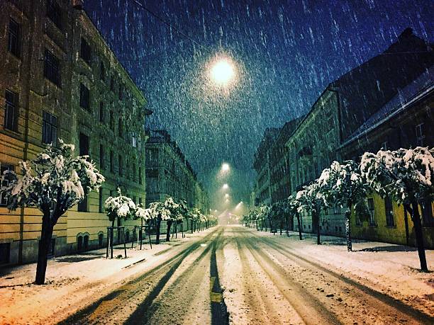 istock Street in spring by night in heavy snowing 525034372
