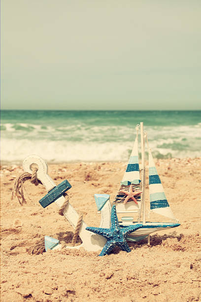 anchor, sailboat on sea sand and ocean horizon