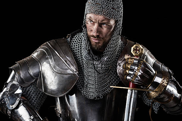 istock Medieval Warrior with chain mail armour and sword 525035620