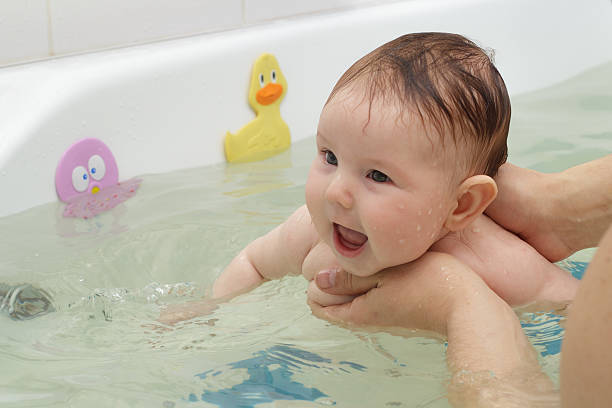 istock Newborn baby bathe and swim 525035694
