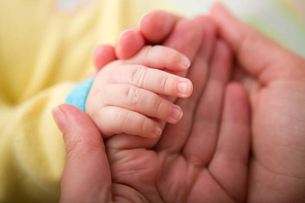 istock Mother holding sleeping baby's hand XXXL 525037787