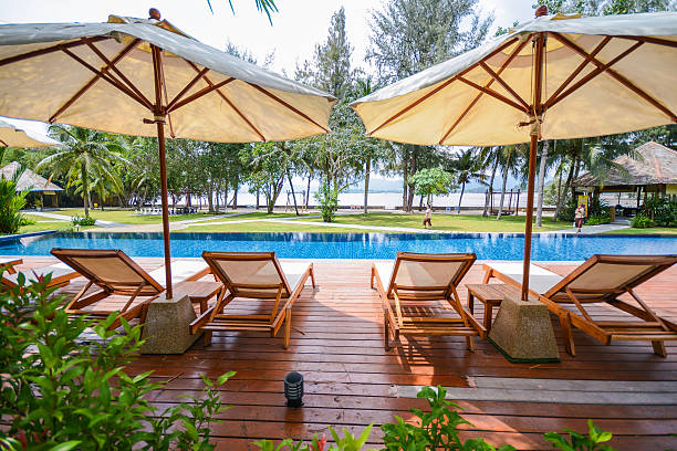 istock beach chair and umbrella side the pool 525039183