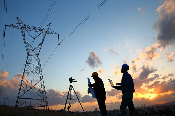 istock Silhouette of engineers workers at electricity station 525040052