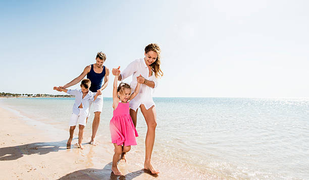 istock Playful young family on the beach. 525040091