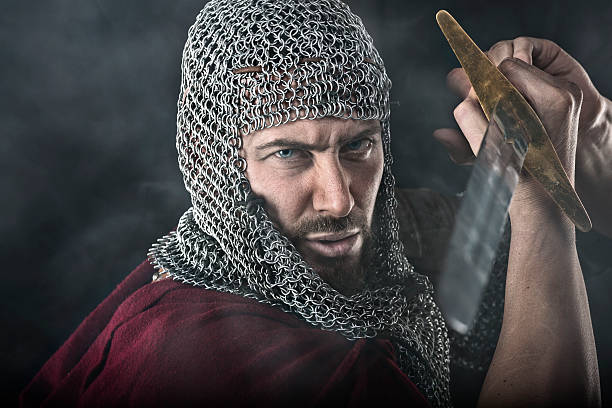istock Medieval Warrior with chain mail armour and sword 525040372