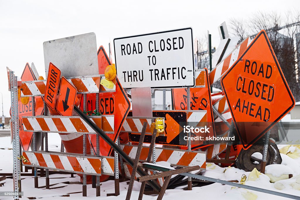 Winter Road Construction Signs A bunch of road construction signs in the snow. Roadblock Stock Photo