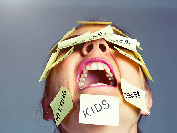 Covered in reminders of things to do, woman freaks out! A furious woman covered with Post-it reminders of things to do has had enough, puts her head back and shrieks! overworked funny stock pictures, royalty-free photos & images