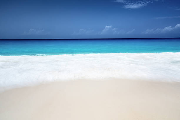 istock seychelles beach in sunny day, long exposure blur 525041136